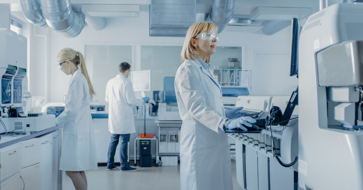 Photo of three scientists working in a lab